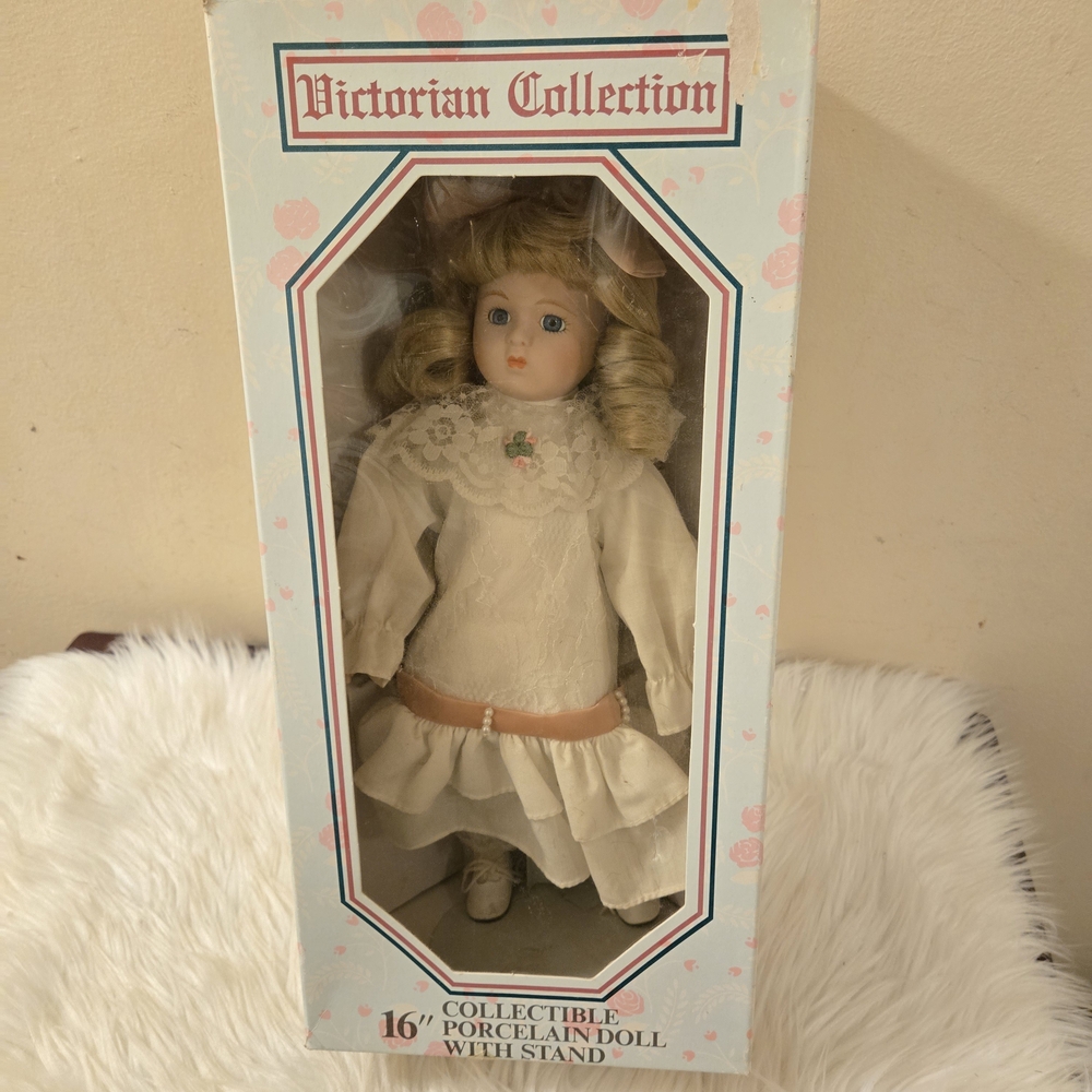 Victorian Collection Porcelain Doll 16" with stand Pre-owned in good condition.